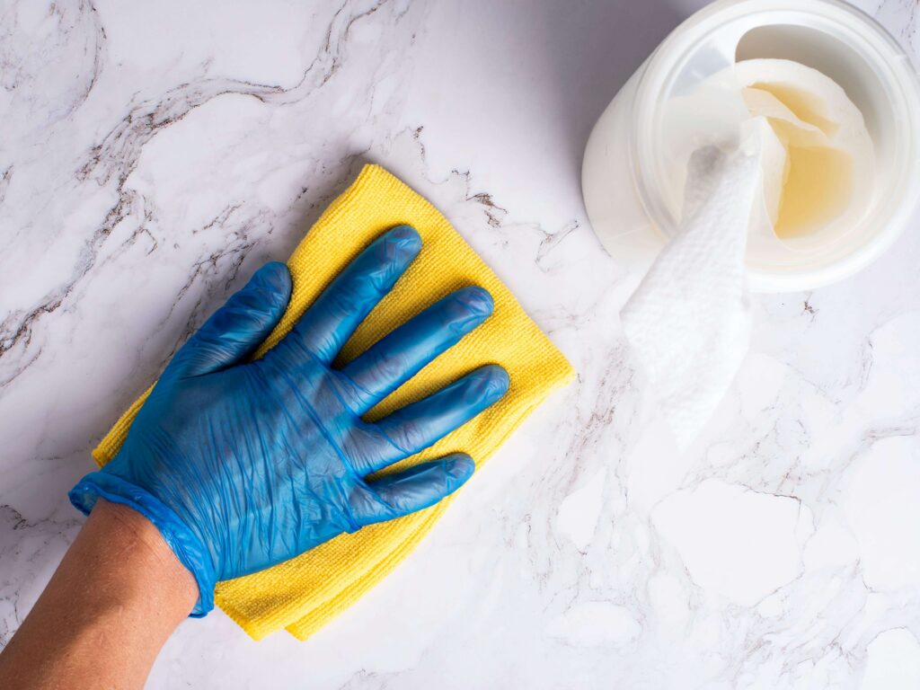 Person Cleaning Worktop
